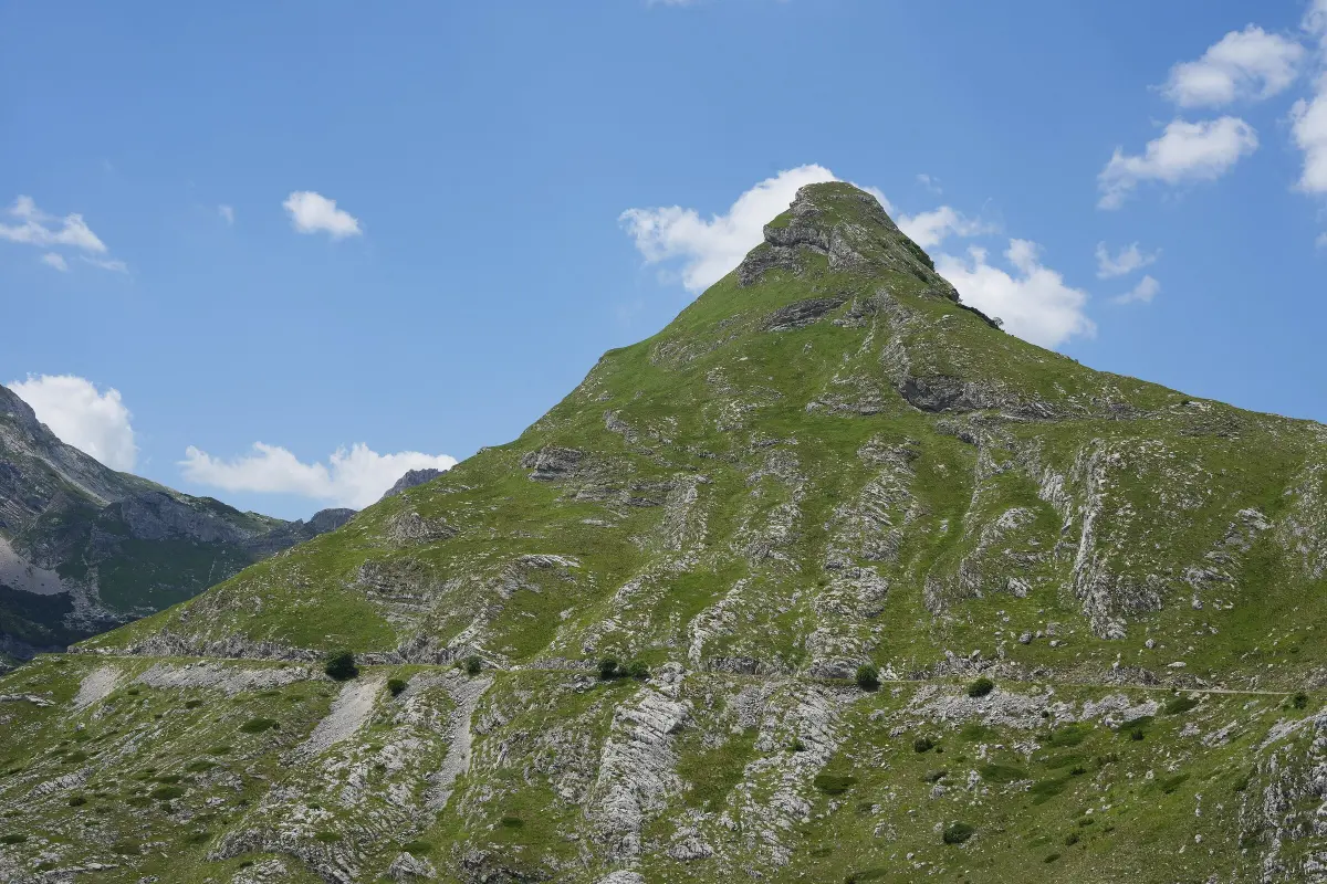 The cone-shaped peak of Stožina above the road to Žabljak