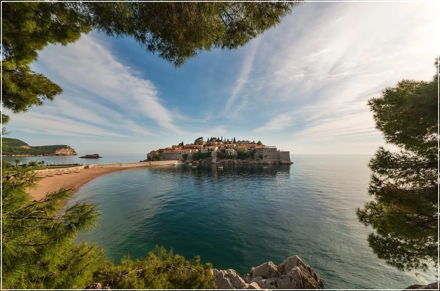 Sveti Stefan seen through the pines above the coast
